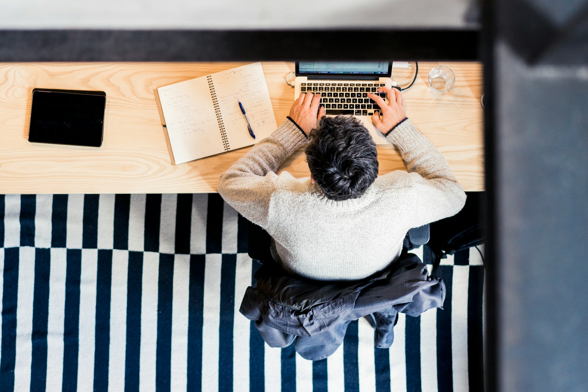Person working at desk with laptop